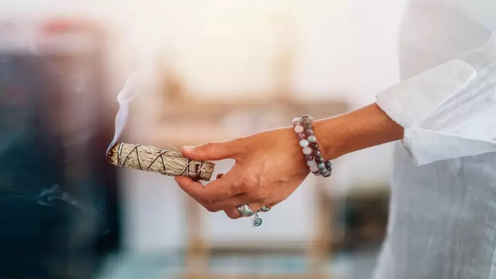 Spiritual cleansing with sage in a calming ceremonial setting